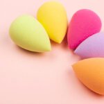 Colorful beauty sponges on pink background. Copy space.